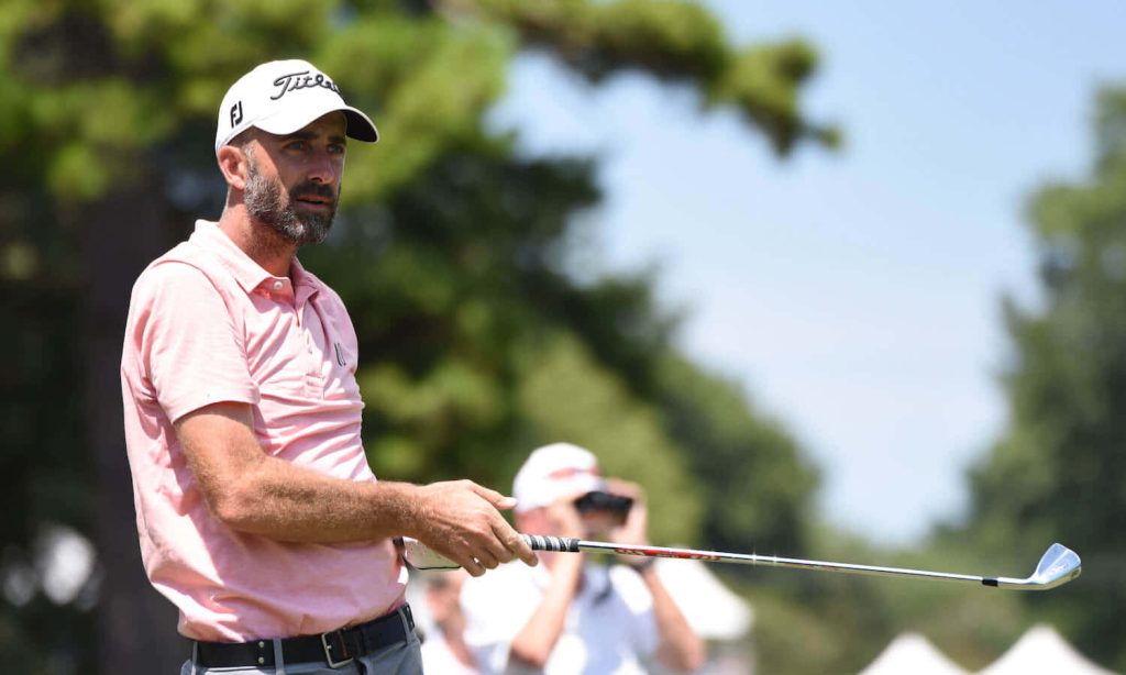 Geoff Ogilvy focused golf swing pale pink polo Titleist cap sunny tree lined course wallpaper