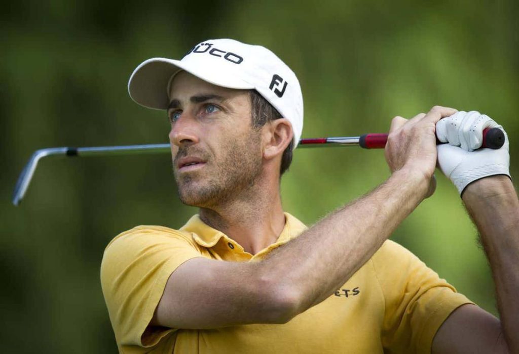 Geoff Ogilvy mid swing in yellow polo white cap golf wallpaper realistic sports background