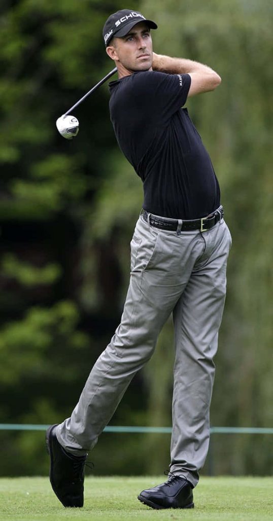 Geoff Ogilvy professional golfer mid-swing in black shirt on lush golf course wallpaper background