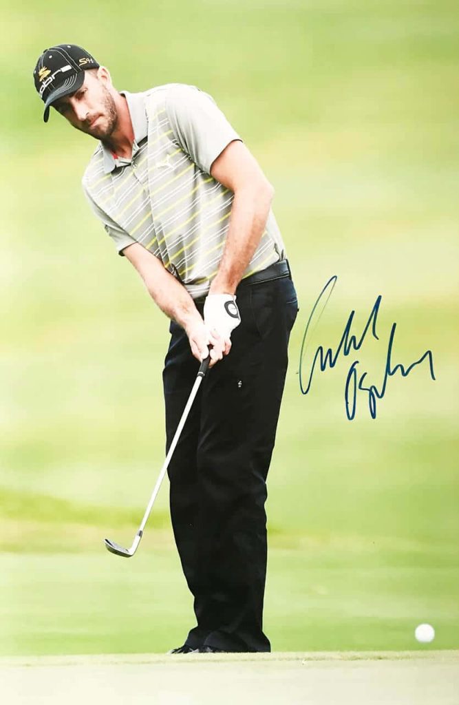 Professional golfer Geoff Ogilvy focused putting on green wearing Cobra cap with autograph wallpaper