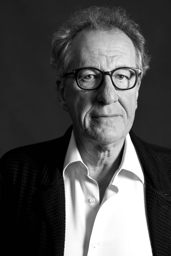 Black and white portrait of Geoffrey Rush with dramatic lighting and contemplative expression wallpaper