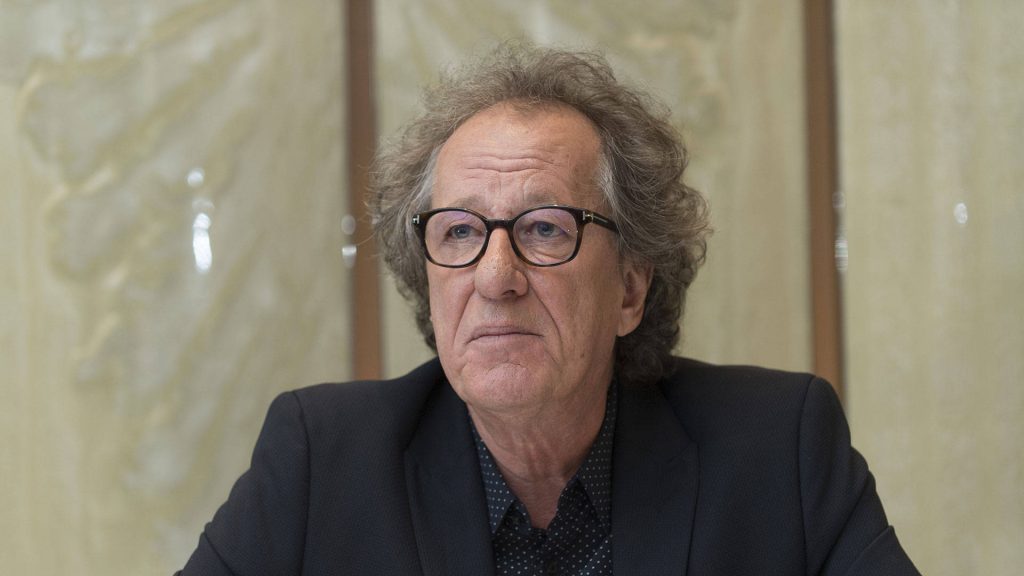 Oscar-winning actor Geoffrey Rush portrait with thick glasses dark suit neutral background wallpaper