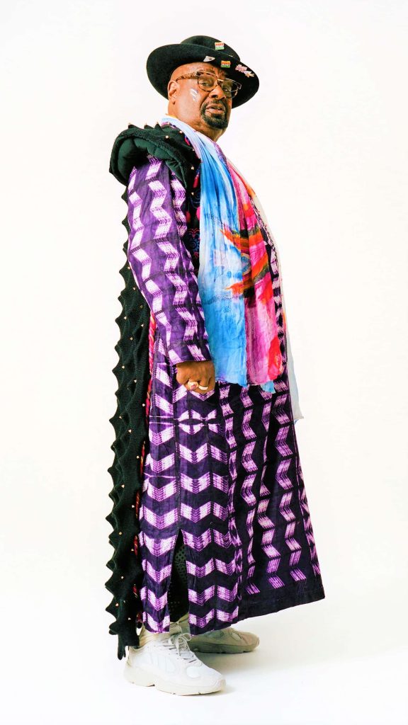 George Clinton Vogue 2018 portrait wearing purple chevron robe black spiked cape colorful scarf hat Wallpaper