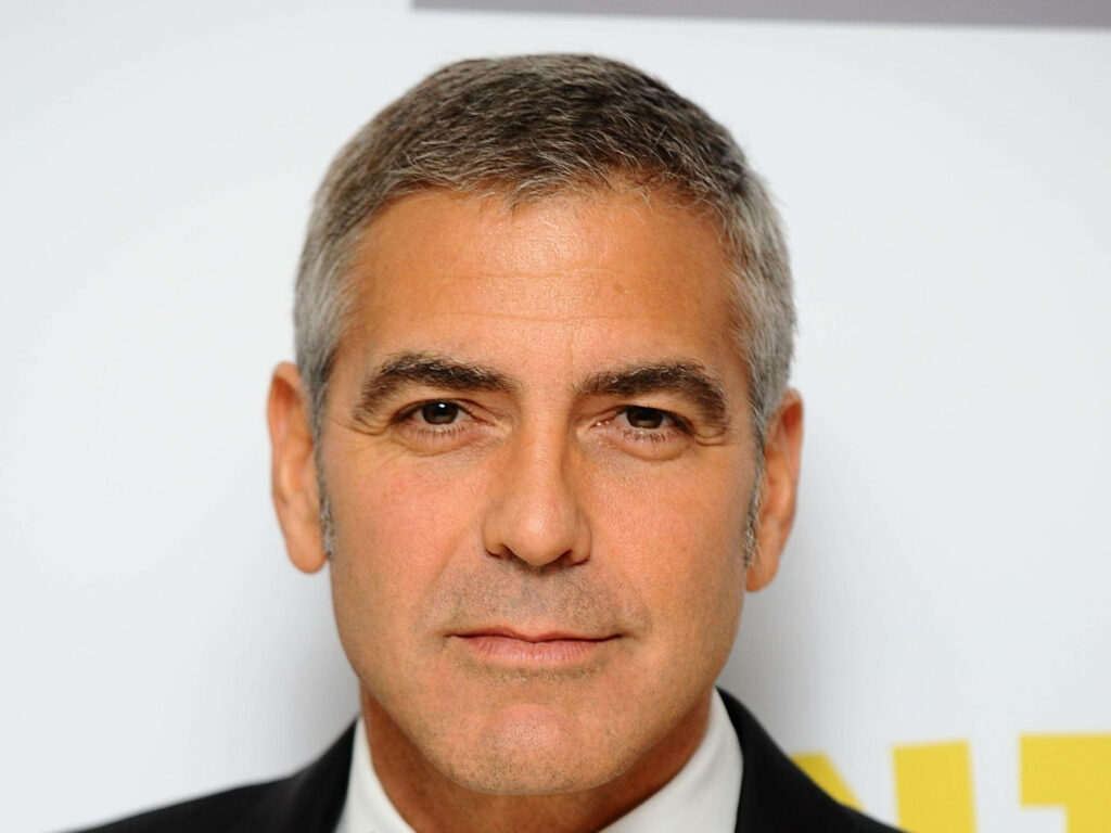 Close-up of George Clooney with salt-and-pepper hair and confident classic style wallpaper background