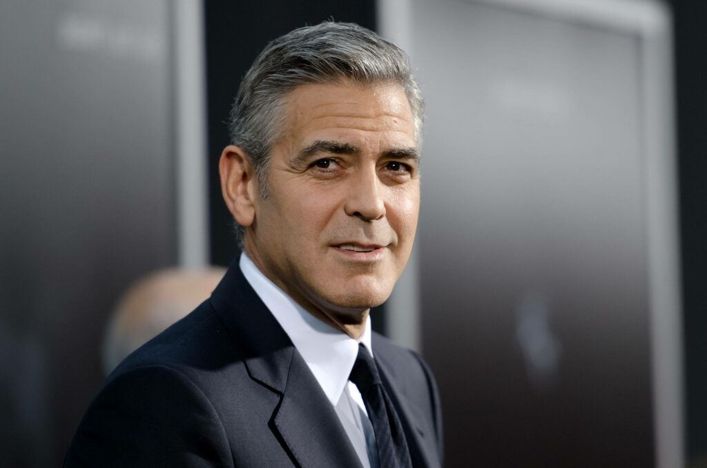 George Clooney in sharp suit on red carpet at Gravity premiere radiating confidence and charm Wallpaper