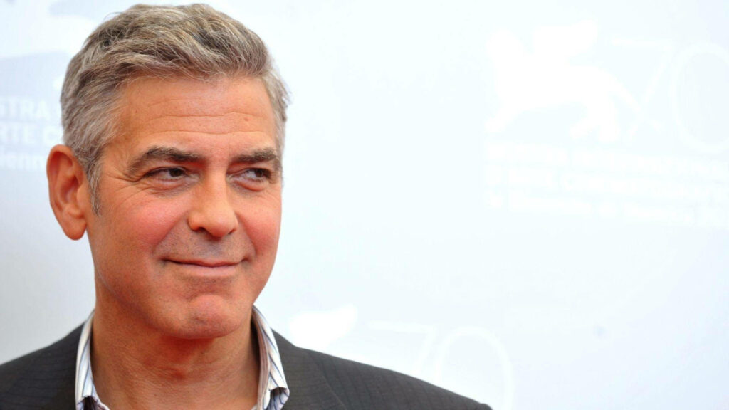 George Clooney confident stylish portrait on light blue background crisp wallpaper image