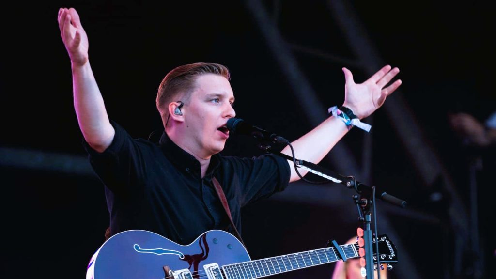 George Ezra live concert performing with Gretsch guitar dark atmospheric stage background wallpaper