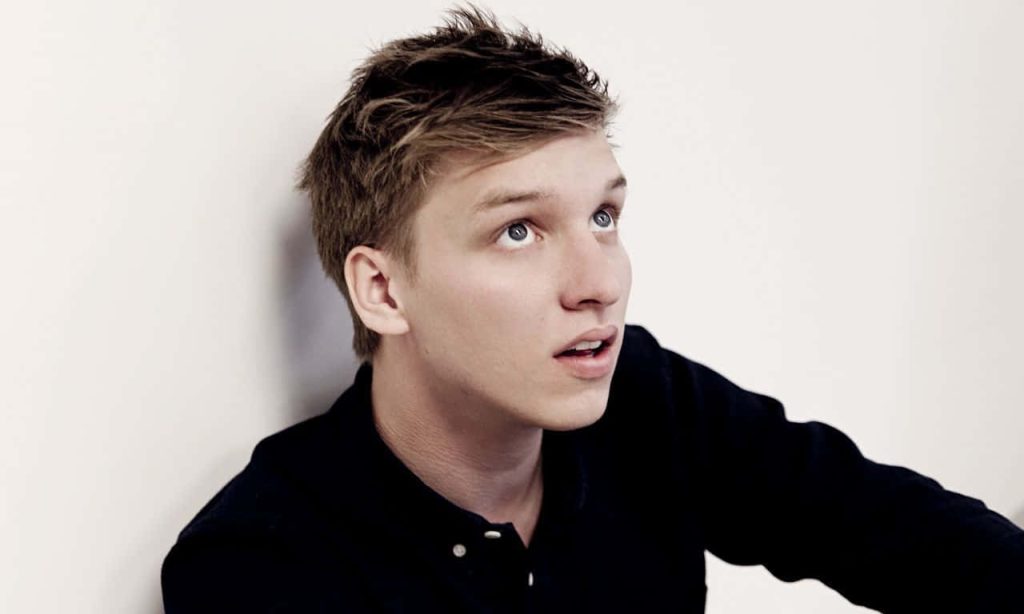 George Ezra studio portrait wallpaper black shirt white background contemplative gaze