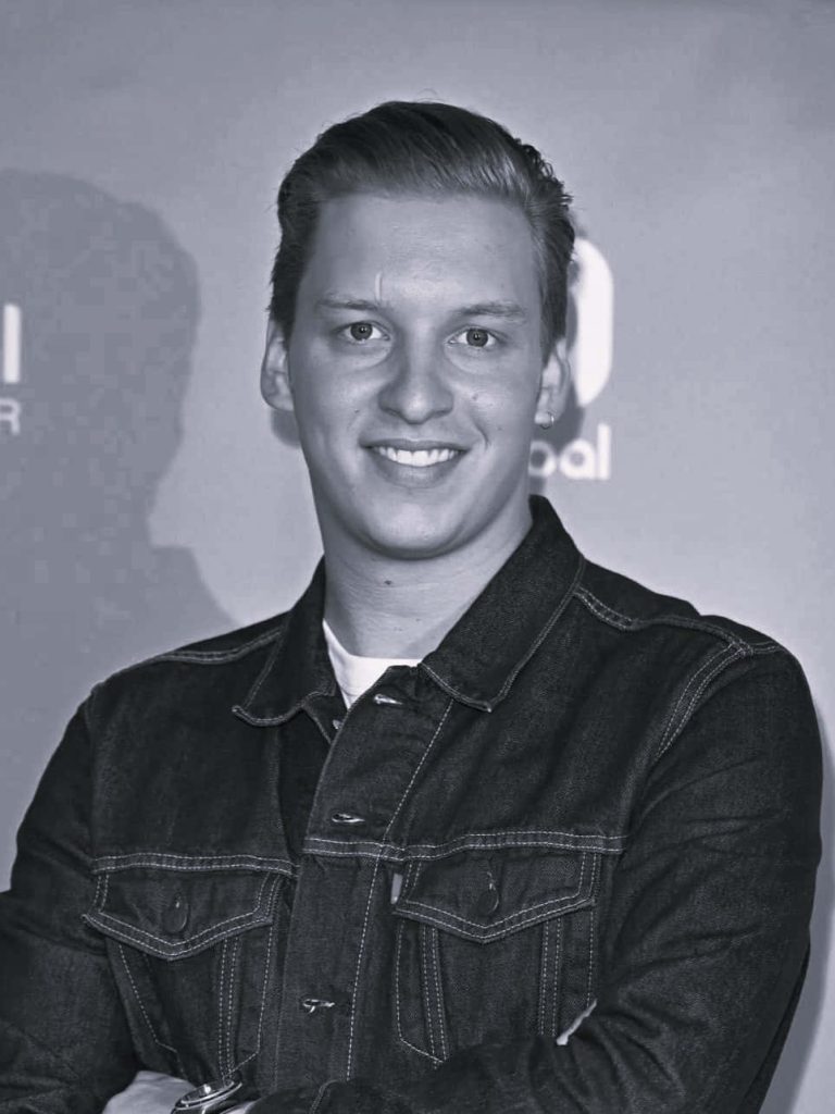 George Ezra monochrome portrait in denim jacket smiling crisp professional lighting wallpaper