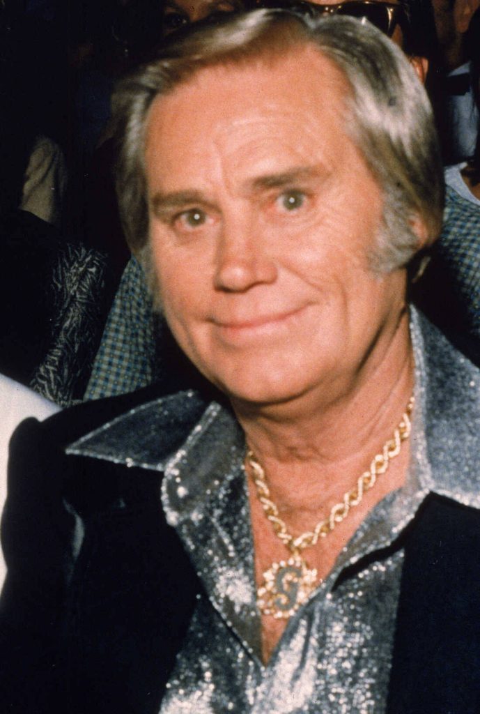 George Jones smiling in sequined silver shirt and gold chain pendant country music legend wallpaper