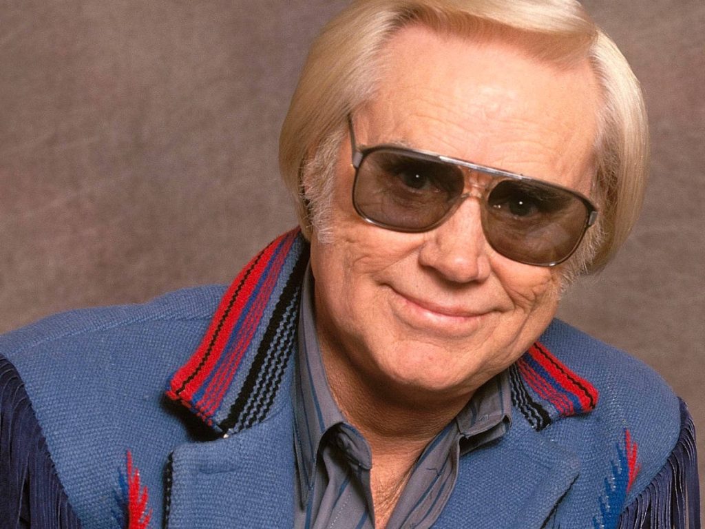 George Jones smiling in blue fringed jacket and sunglasses classic country music portrait wallpaper