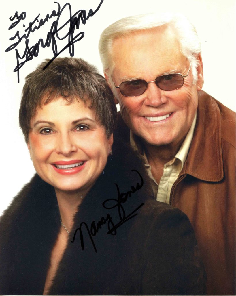 Classic studio portrait of country legend George Jones and wife Nancy with signatures wallpaper