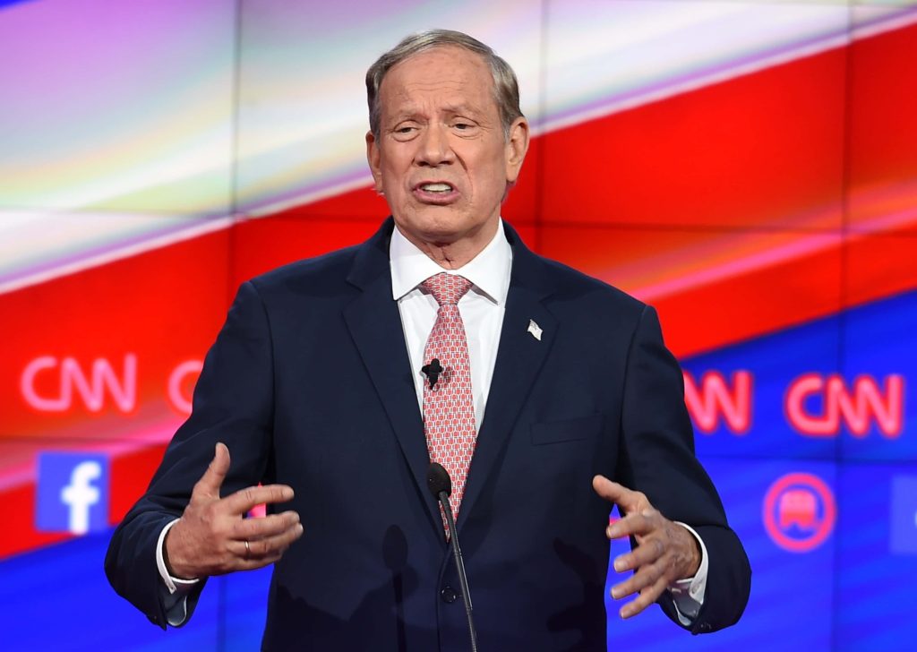 Former NY Governor George Pataki speaks at CNN political debate in navy suit red white blue backdrop Wallpaper