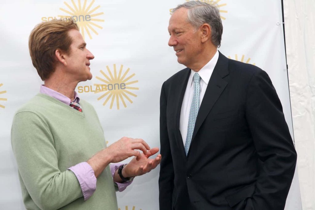 George Pataki in formal attire speaking at SolarOne event with bright professional lighting background Wallpaper