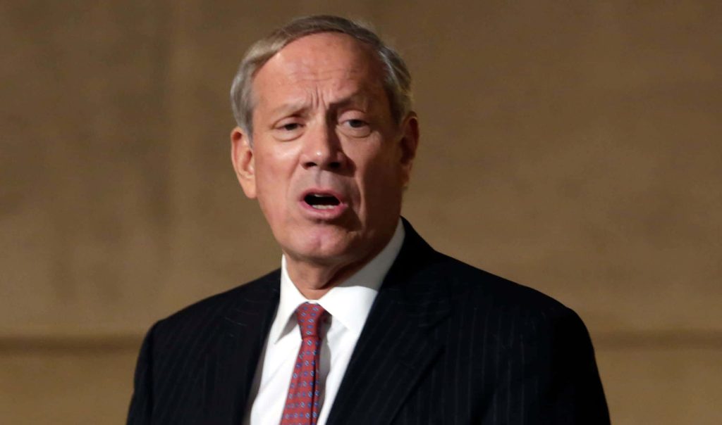 Former New York Governor George Pataki speaking in dark pinstripe suit red tie neutral backdrop Wallpaper