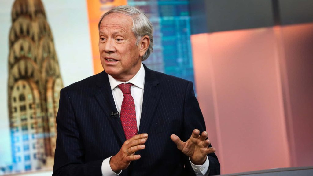 Former New York Governor George Pataki speaking in pinstripe suit with Chrysler Building background Wallpaper