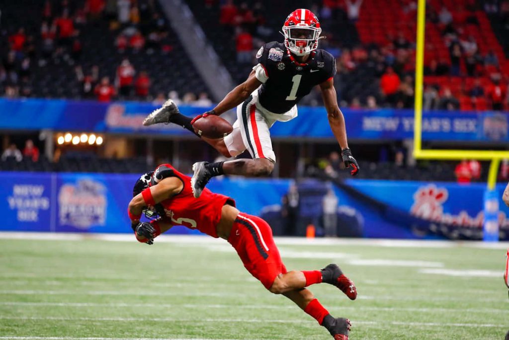 George Pickens hurdle over Cincinnati defender Peach Bowl college football action wallpaper