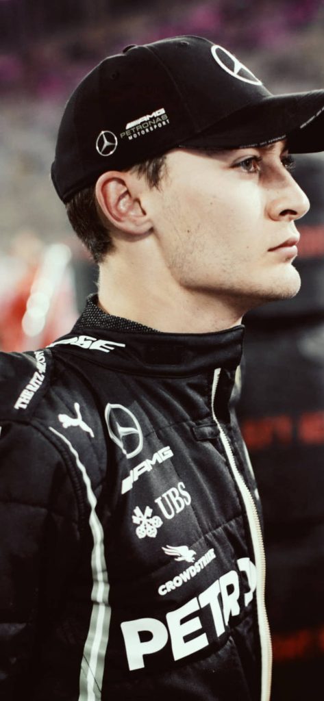 Close-up of Formula 1 driver George Russell in black Mercedes AMG Petronas gear and cap Wallpaper