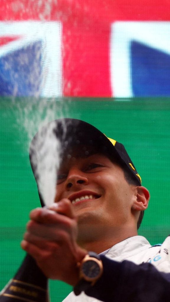 George Russell F1 celebrating victory spraying champagne with Union Jack background wallpaper