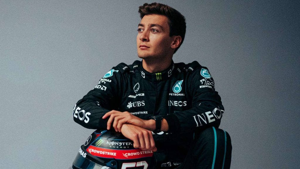 George Russell in Mercedes AMG Petronas race suit with helmet featuring Monster Energy and CrowdStrike logos Wallpaper