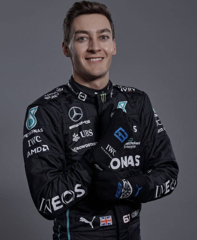 George Russell portrait in black Mercedes AMG Petronas racing suit grey studio background wallpaper