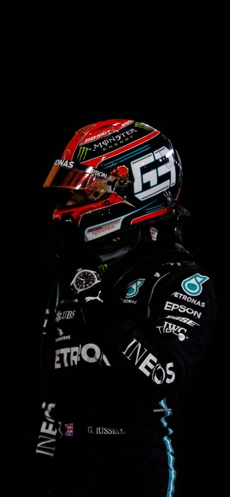 George Russell in black Mercedes AMG Petronas race suit and helmet on dark background wallpaper