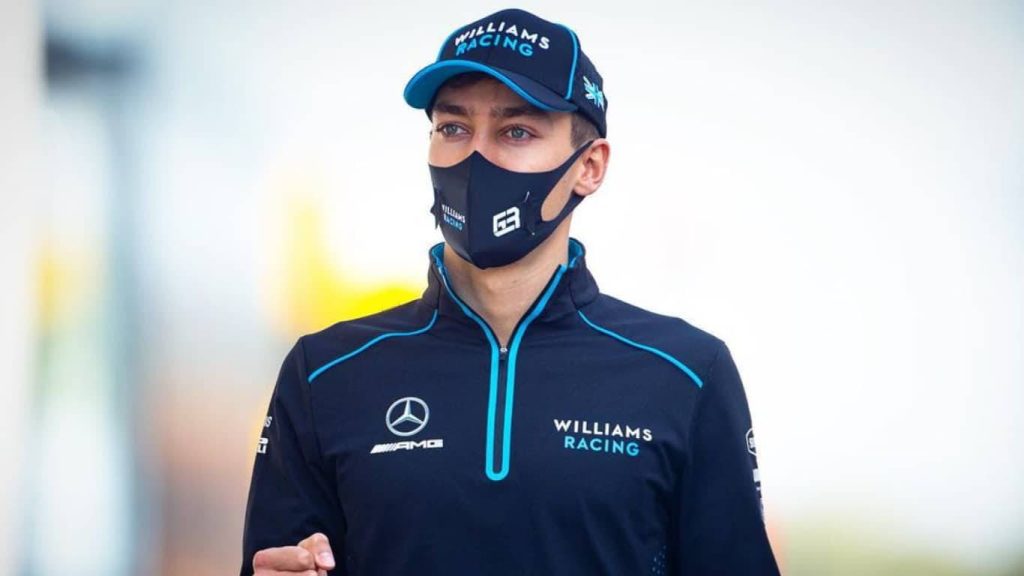 George Russell Williams Racing F1 driver portrait in team gear with branded cap and mask Wallpaper