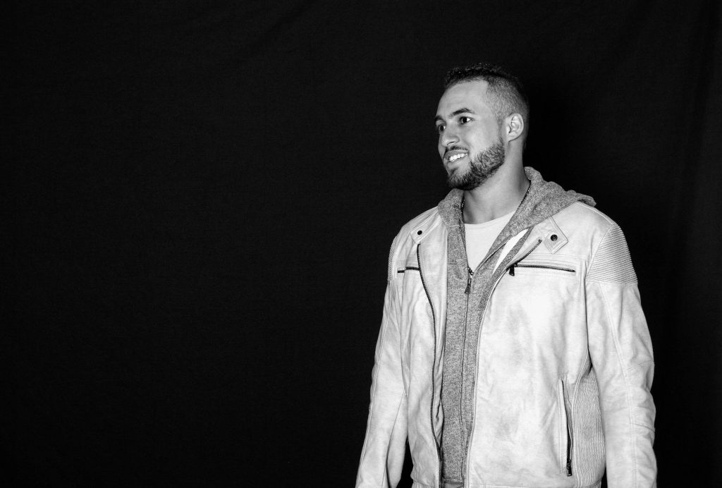 Black and white portrait of MLB star George Springer smiling in casual jacket and hoodie Wallpaper