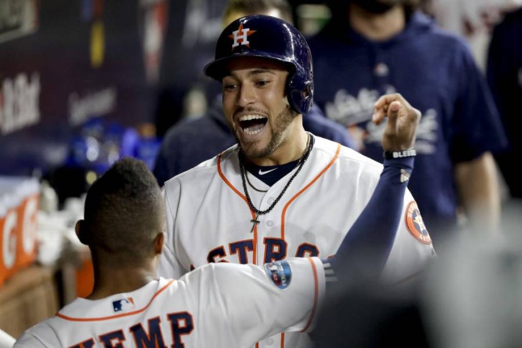 George Springer in white Astros uniform smiling joyfully in dugout dynamic MLB wallpaper background