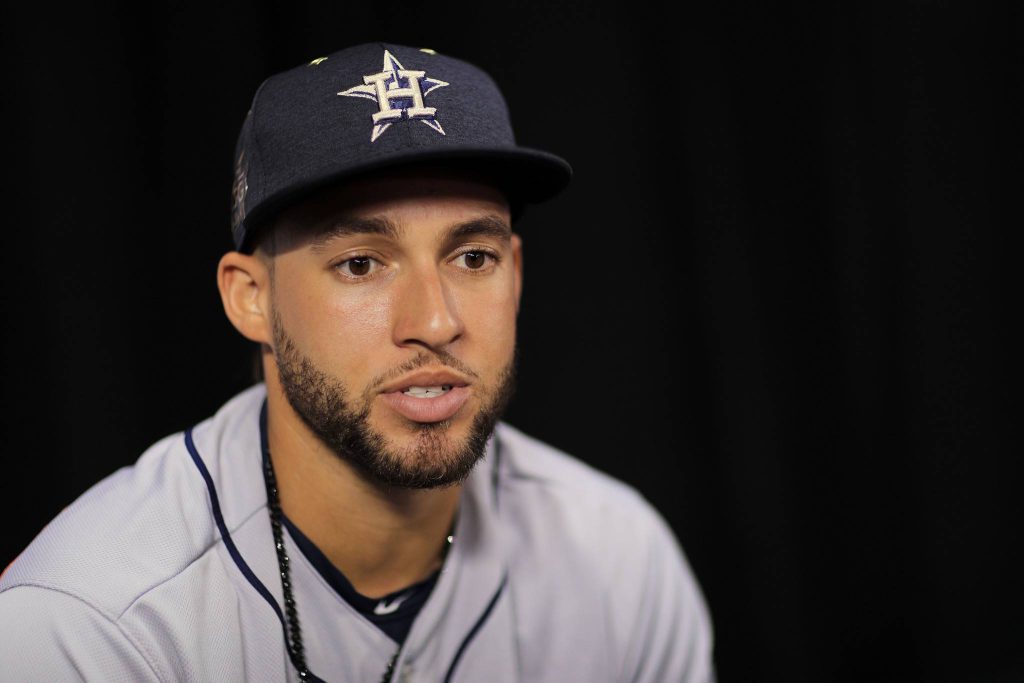 Close-up portrait of MLB star George Springer in Houston Astros cap during interview on black background Wallpaper