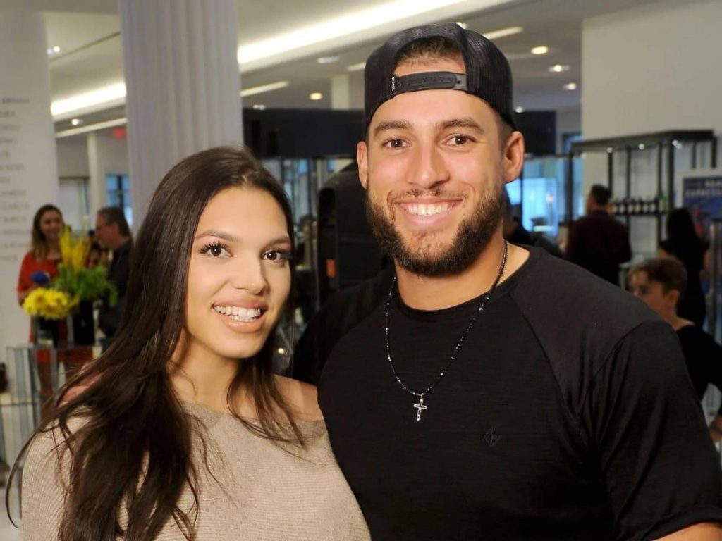 Candid portrait of MLB star George Springer and wife Charlise smiling in bright indoor setting Wallpaper