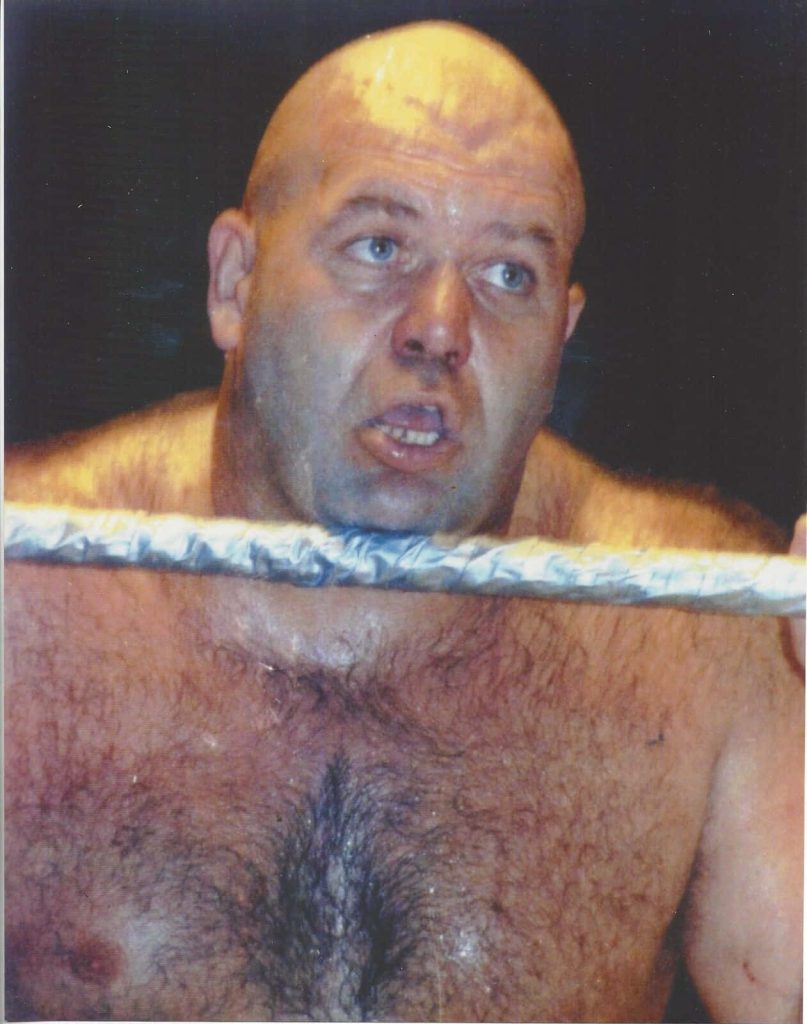 Close-up of wrestling legend George The Animal Steele with signature chest hair and intense look Wallpaper