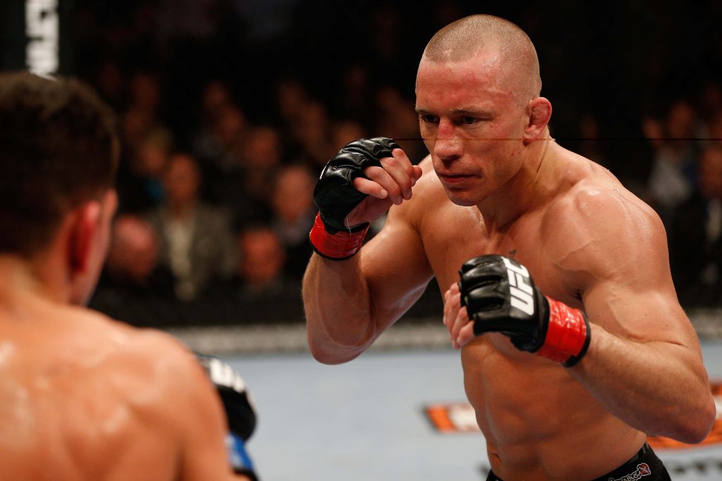 Georges St-Pierre UFC fighter poised in Octagon intense focus combat sports wallpaper background