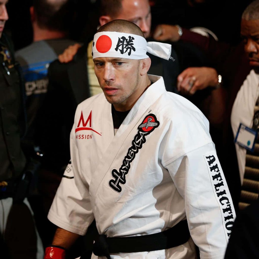 MMA legend Georges St-Pierre in white gi and hachimaki headband ready for fight intense photo Wallpaper