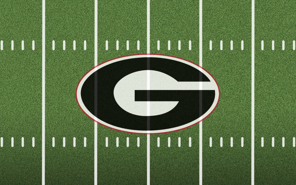 Georgia Bulldogs logo on green football turf with white yard lines HD wallpaper background
