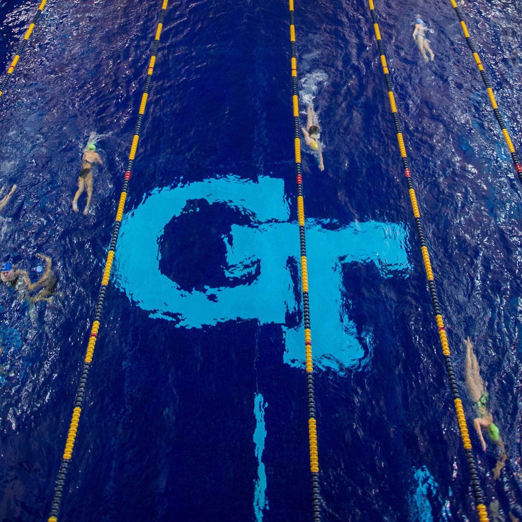 Aerial view of Georgia Tech McAuley Aquatic Center pool with vivid lane markers and GT logo Wallpaper