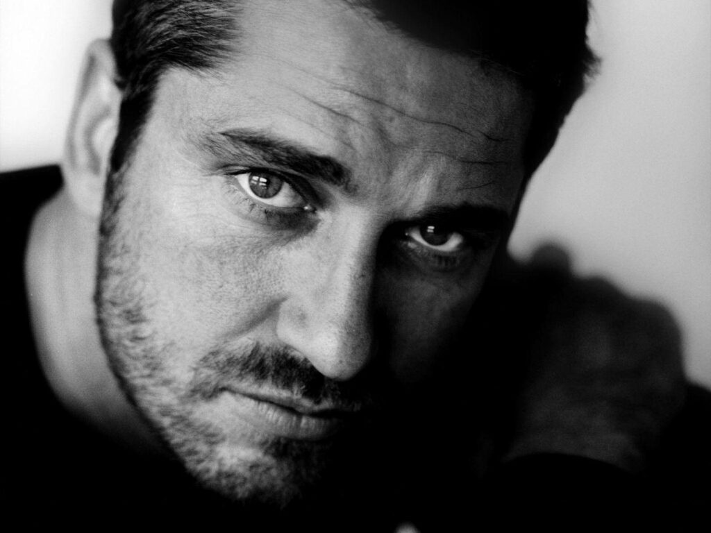 Gerard Butler black and white wallpaper intense gaze rugged features classic portrait background