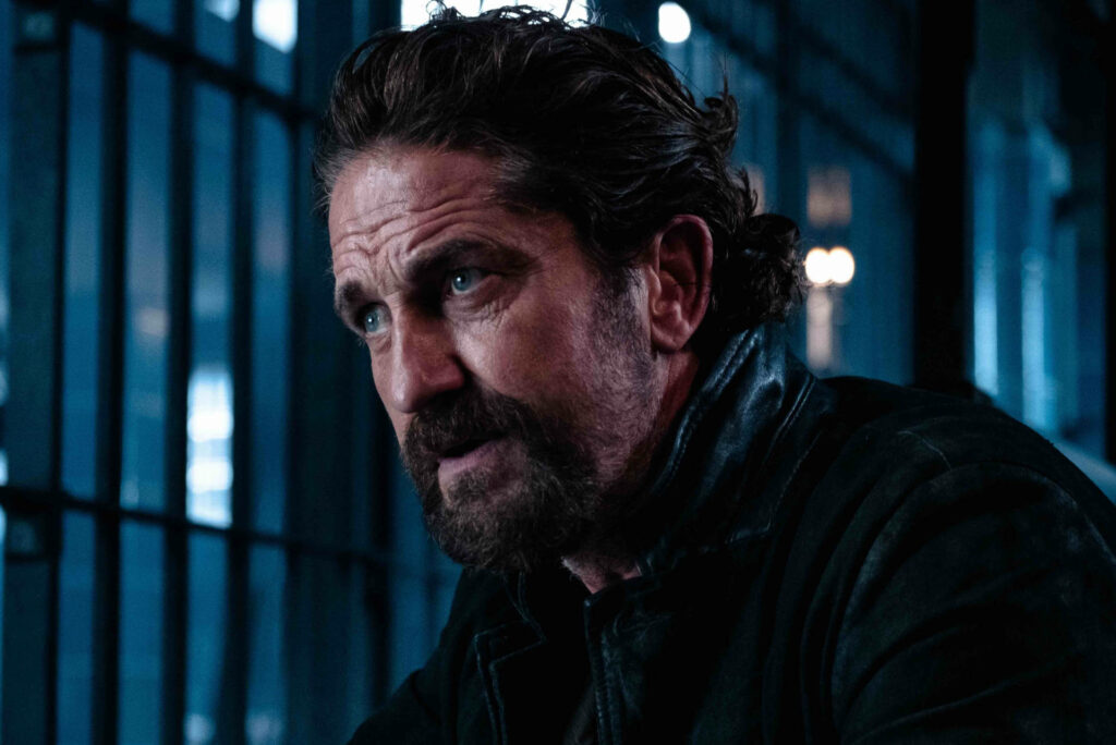 Gerard Butler as Bob Viddick intense focused dramatic scene Copshop 2021 blue-lit jail bars Wallpaper