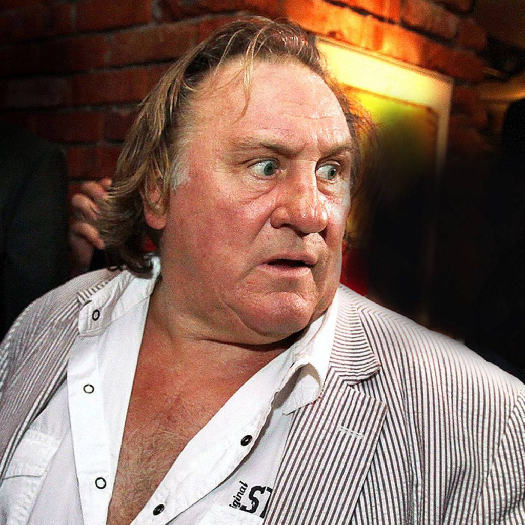 Gérard Depardieu close-up shocked expression striped shirt rustic brick wall wallpaper