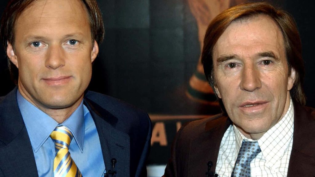 German sports broadcasters Gerhard Delling and Günter Netzer in TV studio interview suits Wallpaper