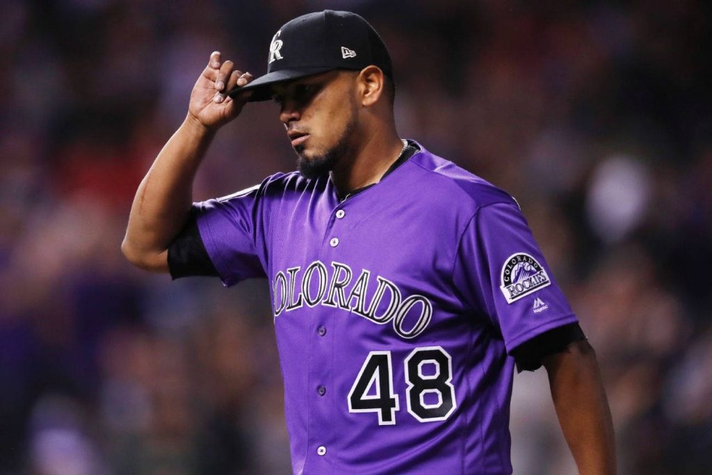 Colorado Rockies pitcher Germán Márquez adjusting cap on mound in purple jersey 48 MLB action Wallpaper