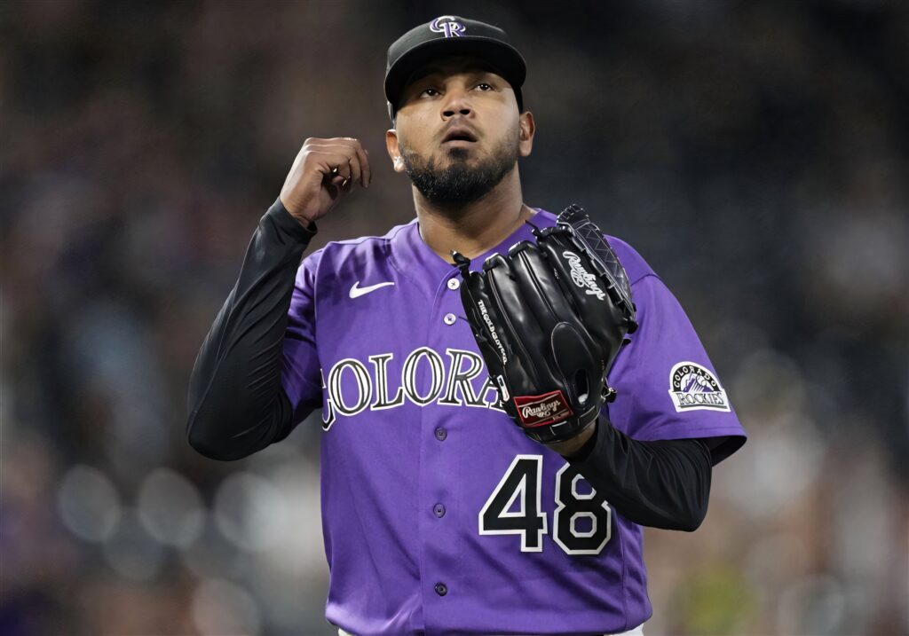 German Marquez pitching in Colorado Rockies purple and black uniform number 48 focused stance Wallpaper