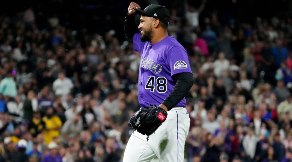 Colorado Rockies pitcher Germán Márquez smiling in purple jersey tipping cap stadium background wallpaper
