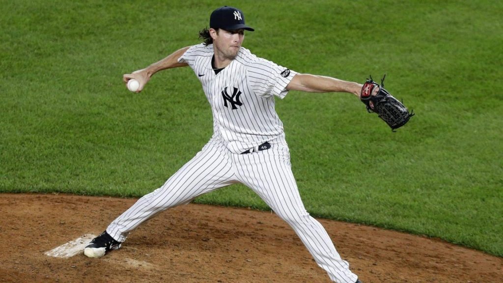 New York Yankees pitcher Gerrit Cole in action mid-pitch wearing pinstripes on the mound Wallpaper