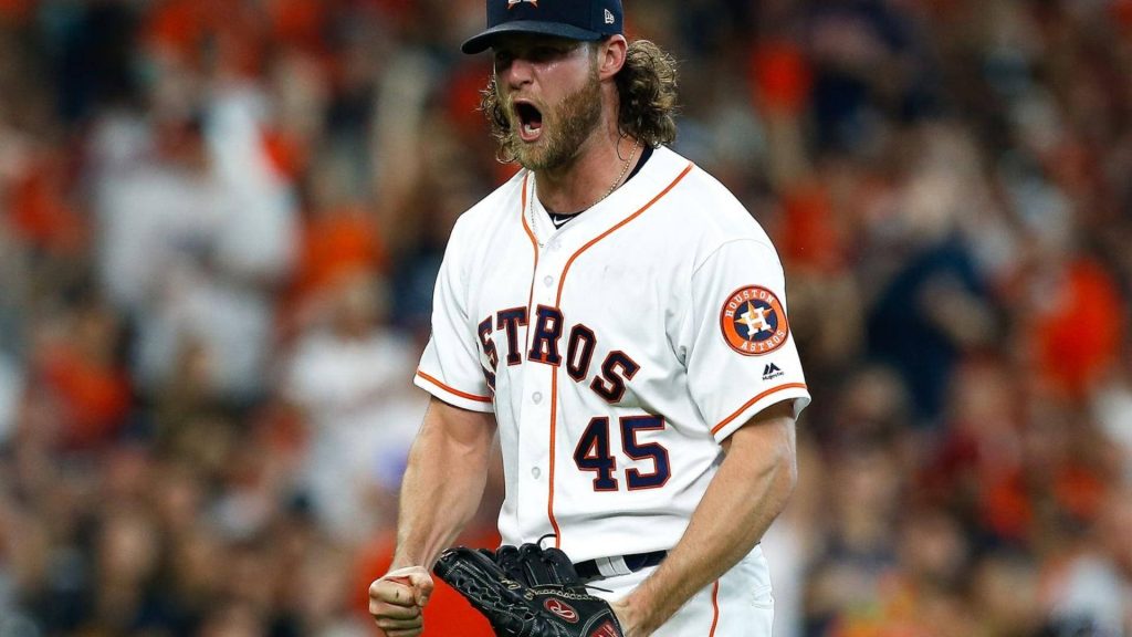 Gerrit Cole Houston Astros pitcher celebrating with fist pump in white jersey #45 stadium crowd Wallpaper
