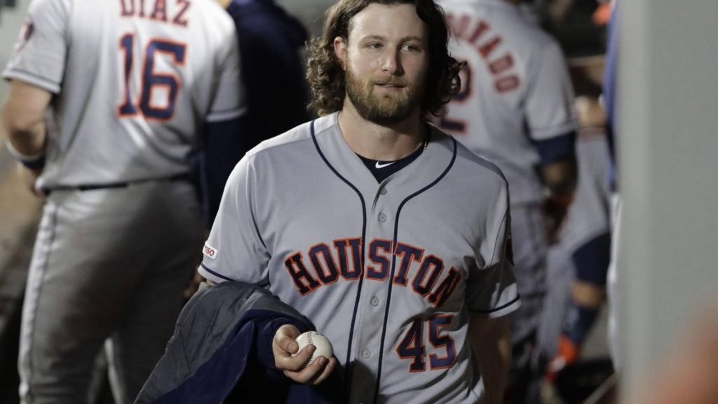 MLB pitcher Gerrit Cole walking in Houston Astros gray jersey number 45 holding baseball wallpaper