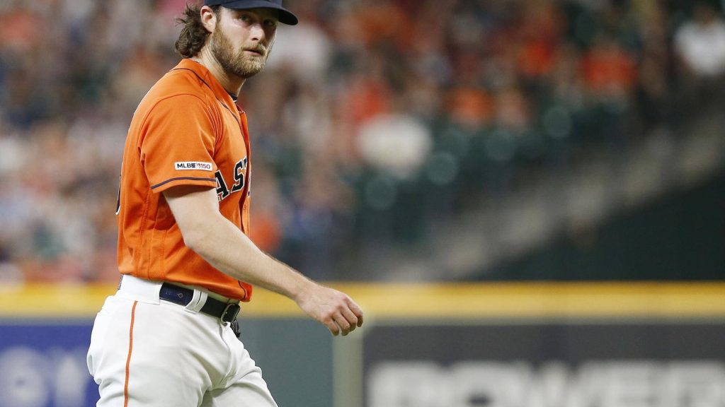 Houston Astros pitcher Gerrit Cole in orange jersey delivering intense pitch MLB 150 patch Wallpaper