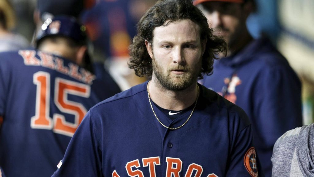 Gerrit Cole close-up in navy Astros jersey showing intense focus and signature long hair and beard Wallpaper