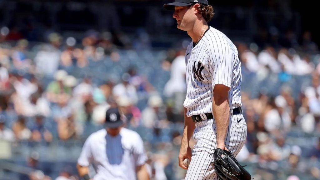 Gerrit Cole Yankees pitcher in home pinstripes on mound with ball and glove MLB wallpaper background