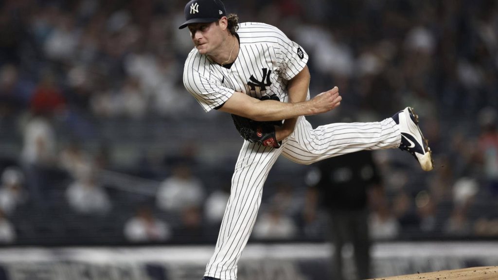 Gerrit Cole pitching intensely in New York Yankees pinstripes dynamic MLB wallpaper background